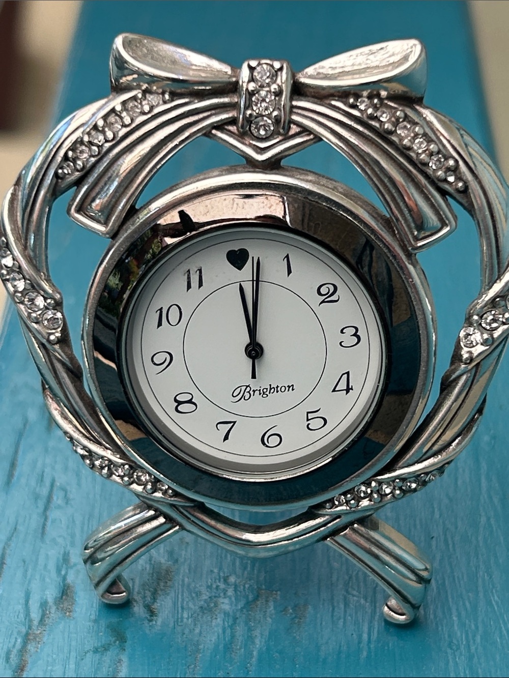 Brighton decorative silver-tone analog desk clock with an ornate bow/scrollwork